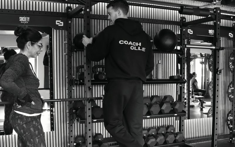 A learner working through a rack setup with a coach